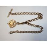 A 9ct gold curb link watch chain by John Grinsell & Co, Birmingham, 38cm long suspended with a 9ct