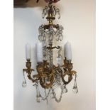 Two similar late 19th century gilt metal and glass chandeliers, one with four branches, the other