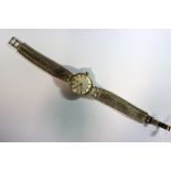 Omega - a lady's 9ct gold cased wristwatch, with silvered dial applied with gold coloured baton