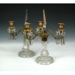 A pair of ormolu and cut glass two branch table lustres, each with obelisk top above pair of