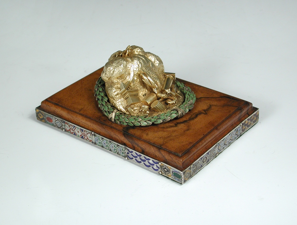 A silver gilt desk ornament or paperweight, modelled as an erupting volcano with a dragon and