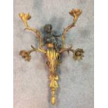 A 19th century ormolu and bronze wall light, the four branch light surmounted with a putto 63cm (