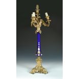 A Victorian gilt bronze and blue glass mounted four branch candelabra, the scrolling arms above a