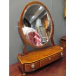 A Regency mahogany bow front dressing table mirror, the base with three drawers, lion mask and