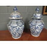 A pair of 20th century Japanese blue and white vases and covers