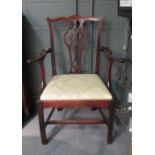 Three George III mahogany dining chairs with drop-in seats and an elbow chair (4)