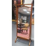 A large mahogany framed cheval dressing mirror with brass finials