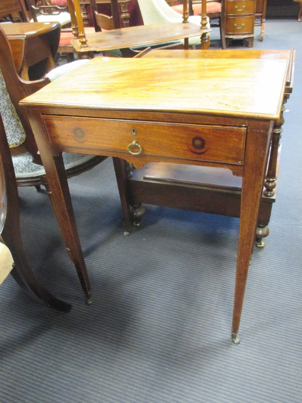 A George III mahogany side table with single drawer over tapering square legs on castors