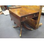 A Regency mahogany pedestal Pembroke table, fitted with a drawer, on four swept legs and brass paw