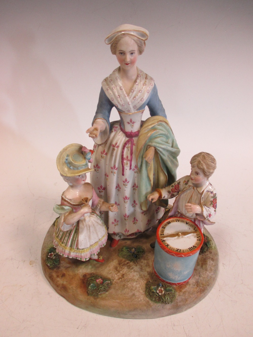 A Dresden porcelain group of mother and children with a drum