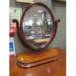 A Victorian mahogany oval swing mirror