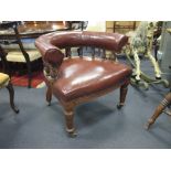 A late Victorian walnut framed library chair, upholstered in a dark tan immitation leather