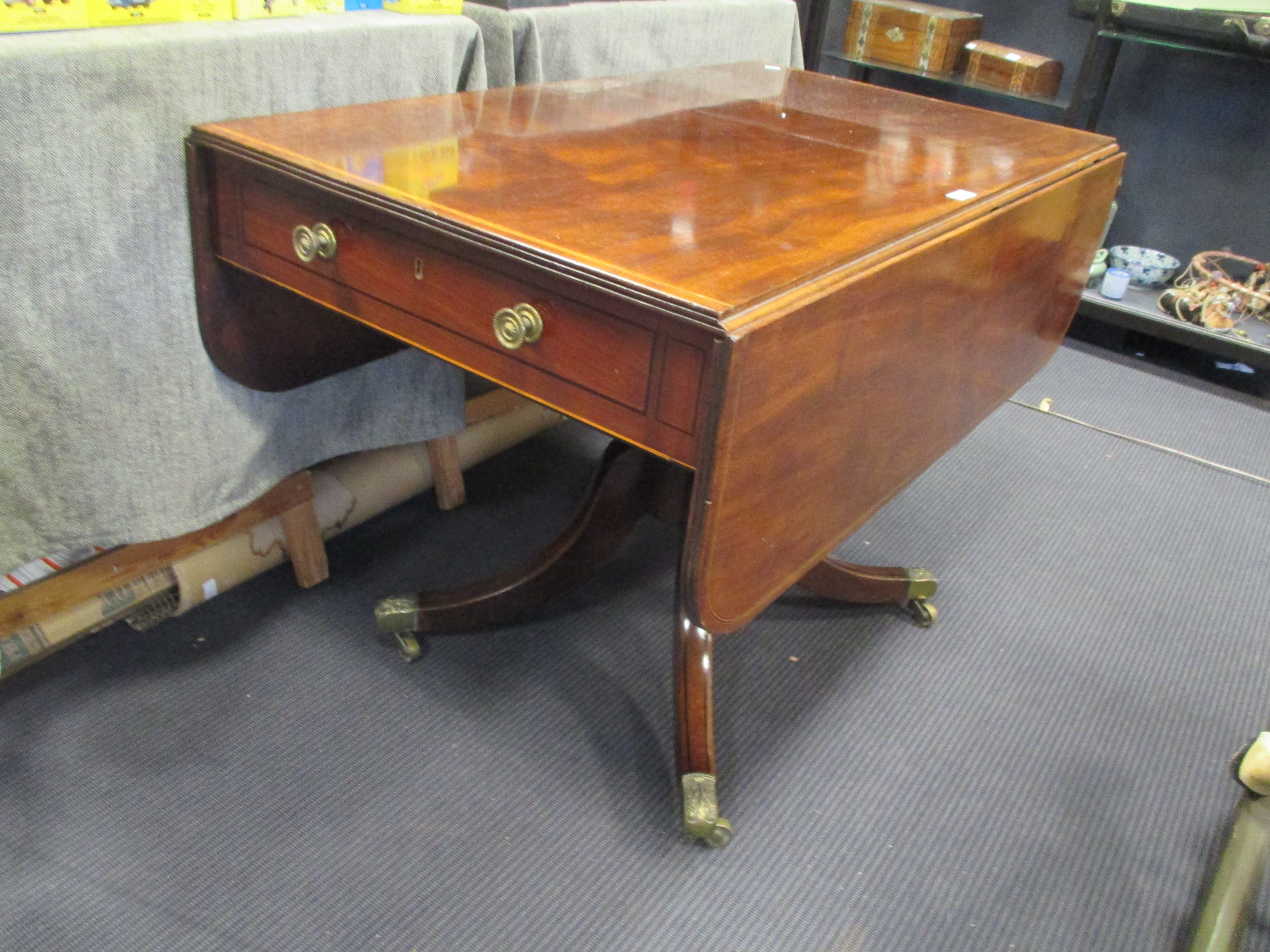 A George IV mahogany pedestal pembroke table with fittend end drawer, and satinwood and ebony line