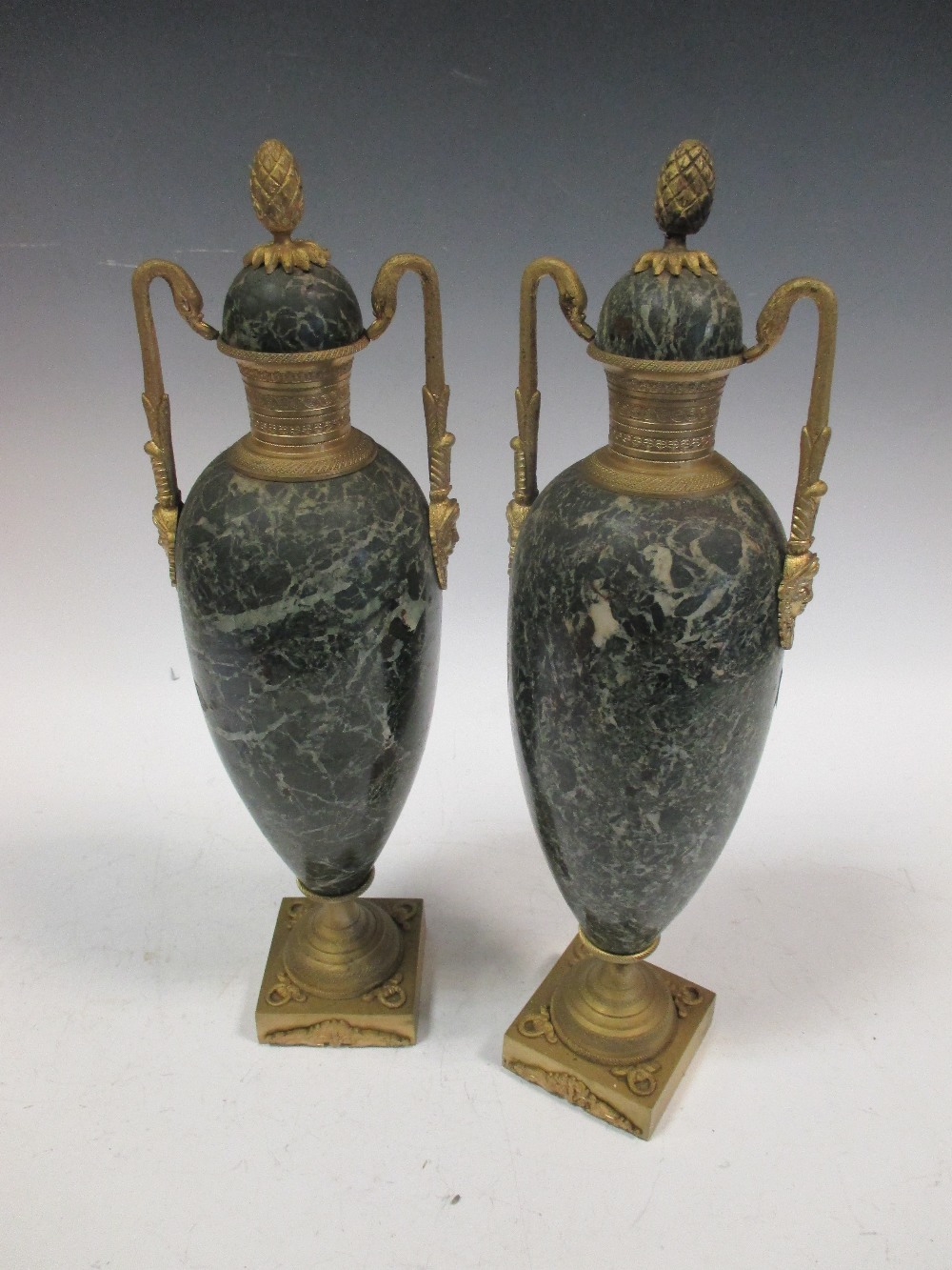 A pair of late 19th century green marble and gilt metal mounted urns, 42cm