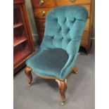 A Victorian rosewood button back nursing chair on cabriole legs