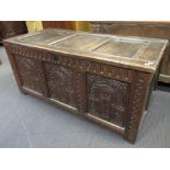 An 18th century carved oak panelled coffer, 59 x 129 x 60cm