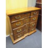 A reproduction elm veneered chest of four long moulded drawers, 82 x 86 x 33cm