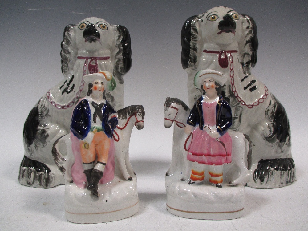 A pair of Staffordshire dogs and a pair of Staffordshire flatbacks