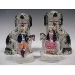 A pair of Staffordshire dogs and a pair of Staffordshire flatbacks