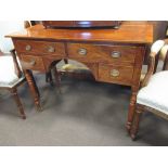 A Regency mahogany kneehole dressing table fitted with two long and two short drawers on turned legs