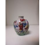 A 19th century snuff bottle, the sides moulded in relief and coloured in famille rose enamels, a red