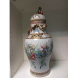 A 19th century Canton vase and cover, the baluster shape painted with a mock battle between horsemen