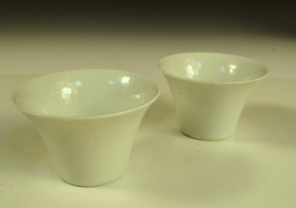 Two 19th century white glazed cups, each of the flared sides with anhua decoration of lotus, the