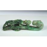 A jadeite belt hook, the emerald mottled stone pierced and carved with a dragon on the body facing