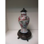 A late 16th/early 17th century wucai vase with wood cover and a stand, the baluster body painted