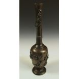 A late 19th/early 20th century bronze tall and slender vase, a dragon cast entwining the waisted