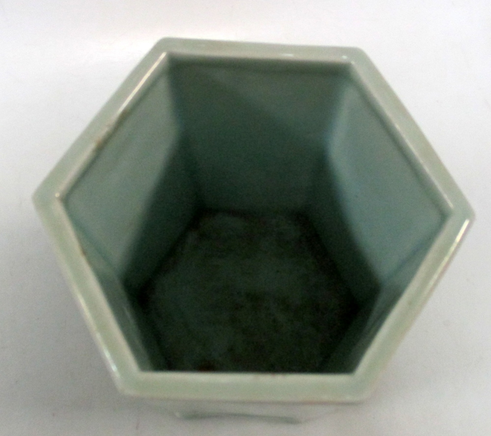 A pale celadon hexagonal brush pot, each side panel moulded in low relief with a different flowering - Image 4 of 5