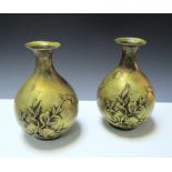 A pair of gold splashed polished bronze vases, each cast in relief on one side with a bat flying