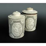 A pair of 19th century ivory tea cannisters and covers, the cylindrical bodies carved with floral