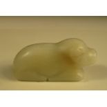 A nephrite jade dog, possibly Song or Ming, the pale grey stone simply smoothed and carved in the