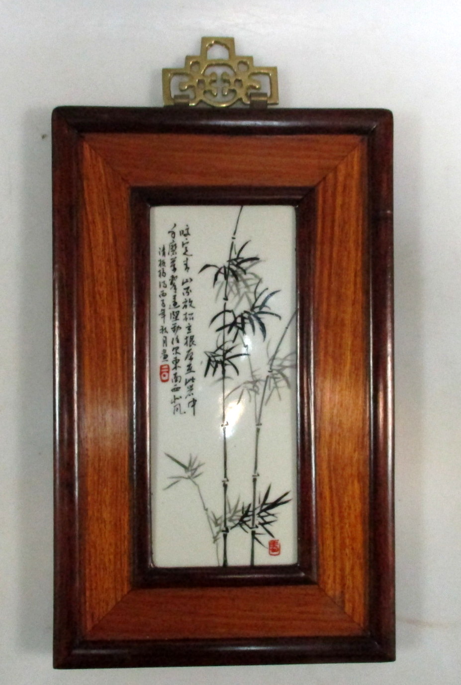 A framed Republic Period plaque painted in tones of black and grey with bamboo in the manner of Xu