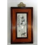 A framed Republic Period plaque painted in tones of black and grey with bamboo in the manner of Xu