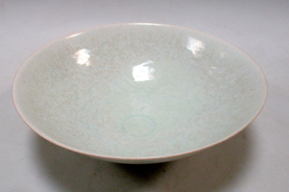 A Qingbai bowl, the misty blue glaze with a slight crackle over incised lotus scrolling on the