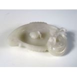 A 20th century mutton fat jade brush washer carved in the shape of a bird with a fish leaping from