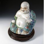 An early 20th century figure of Budai seated with his bag in his right hand and a gilt rosary in his