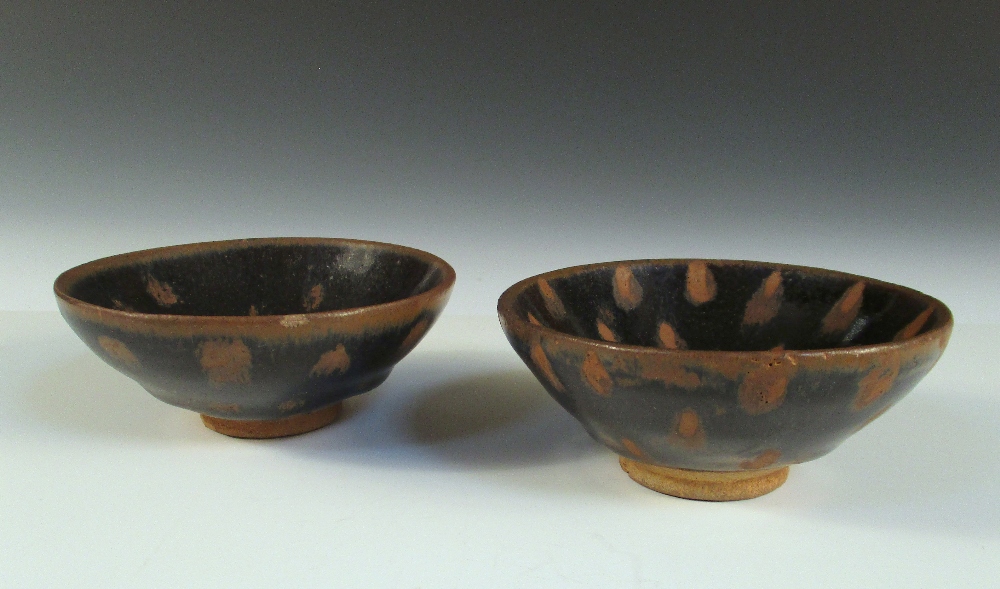 A pair of 'Oil Spot' bowls, the rounded conical shaped glazed in the Song style with brown spots