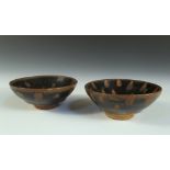 A pair of 'Oil Spot' bowls, the rounded conical shaped glazed in the Song style with brown spots