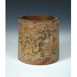 A 19th century bamboo brush pot the exterior carved in relief with sages and attendants beneath