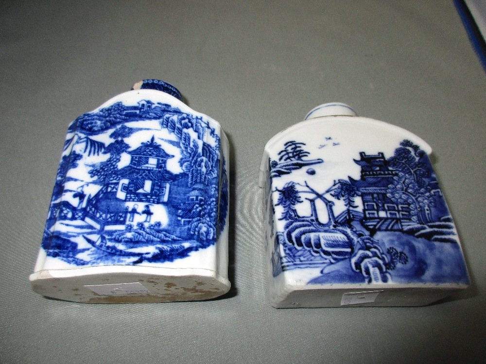 A 18th century blue and white and an English creamware tea caddy, the first painted with pavilions