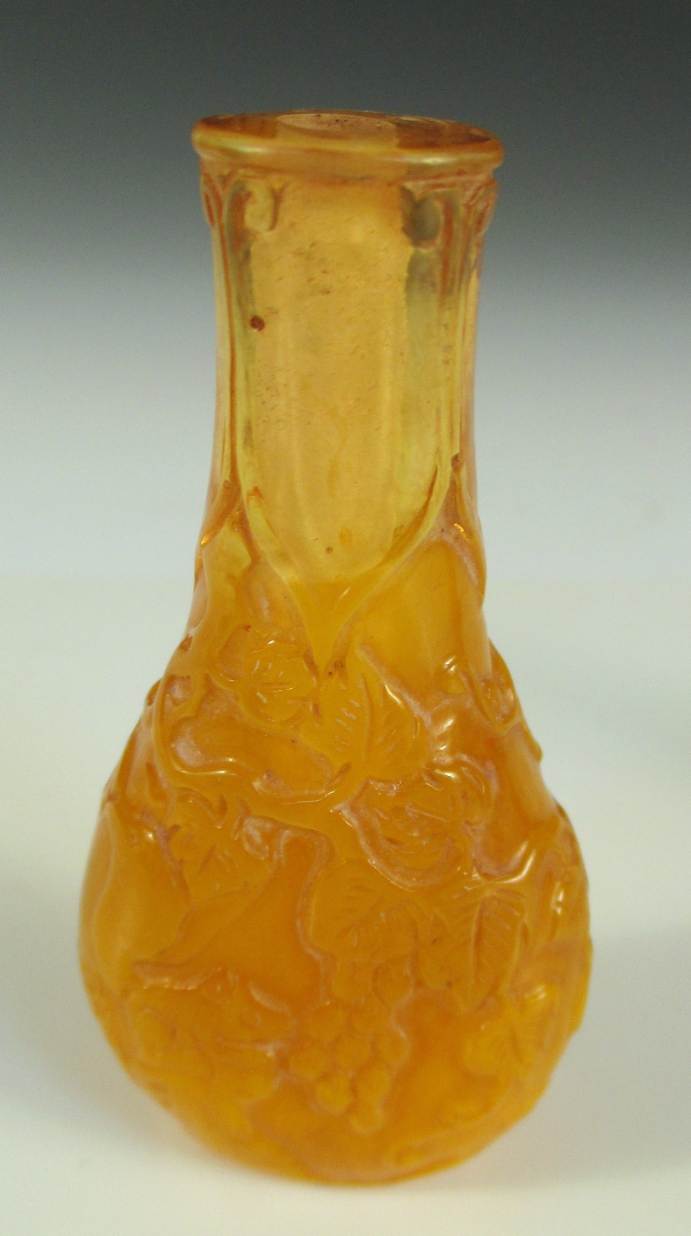 Two moulded glass snuff bottles and a stopper, the flattened bottle shape of the amber example - Image 5 of 6