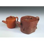 Two Yixing tea pots and covers, the smaller of rounded cylindrical shape, the cover with two loose