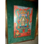 A 20th century Tibetan Thangka painted with a white skinned deity standing within a gilt mandala