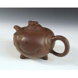 A Yixing tea pot and cover, the compressed spherical shape of the body with lobed panels above three