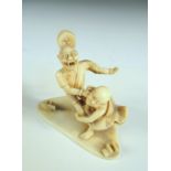 An early 20th century marine ivory okimono, depicting a monk wrestling Raiden, the thunder god