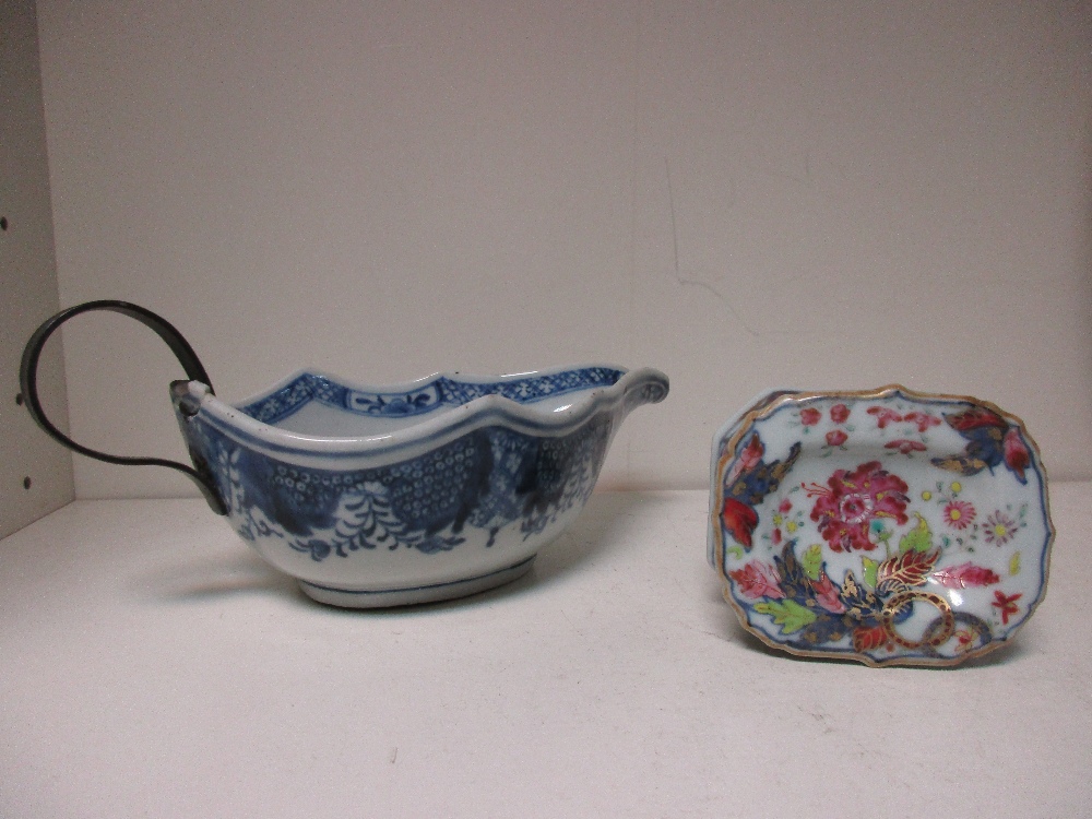 An 18th century Chinese trencher salt and blue and white sauceboat, the salt painted with a