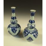 A pair of Kangxi style blue and white double gourd vases, the cylindrical necks with flared rims